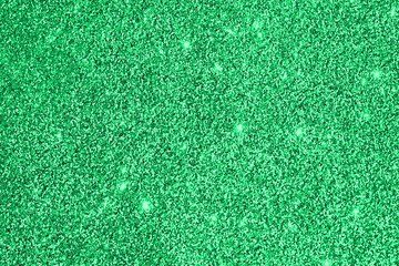 Green glitter sparkle background. Christmas shiny easter abstract texture. Greeting card template. Copy space