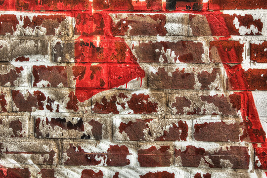 Fototapeta Wall of red bricks with rest of white and red color for abstract backgrounds.