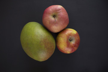 Mango and Apples on black background