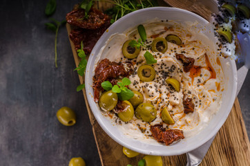Fresh cheese with olives, dried tomatoes