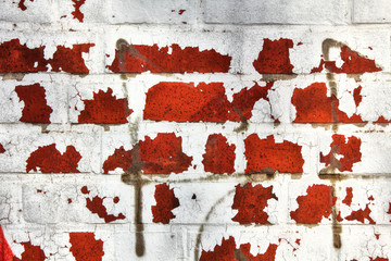 Wall of red bricks with rest of white color for abstract backgrounds. Germany