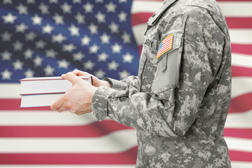 USA army soldier holding books in his hands