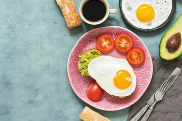 Scrambled eggs with guacamole on bread . Fresh Breakfast, coffee and puff. Copy space, top view.