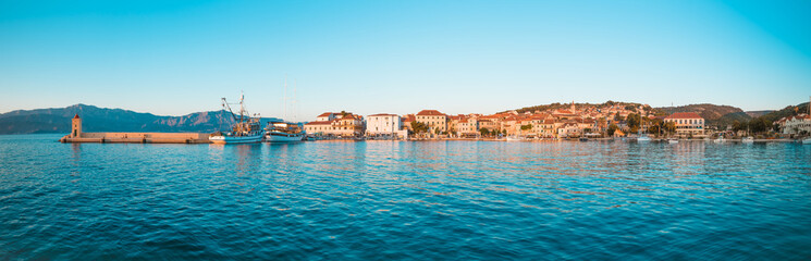 Fototapeta na wymiar Fishing trawler and a boat in the harbor of a small town Postira - Croatia, island Brac