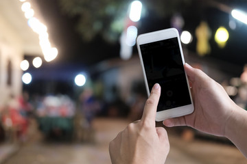 smartphone with bokeh on hand and empty screen.