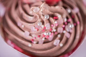 close up of chocolate cream muffin cupcake top sprinkles valentine wedding concept 