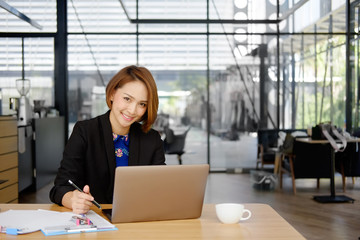 Businesswoman working on table in office.