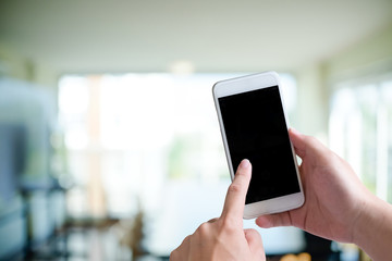 Cropped shot of hand touch smartphone with empty screen.