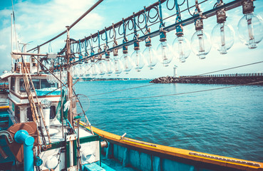 Squid fishing boat entering port in the morning - Jeju island, South Korea