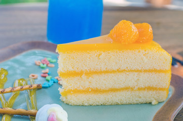 orange cake and colorful sugar sprinkles  on plate