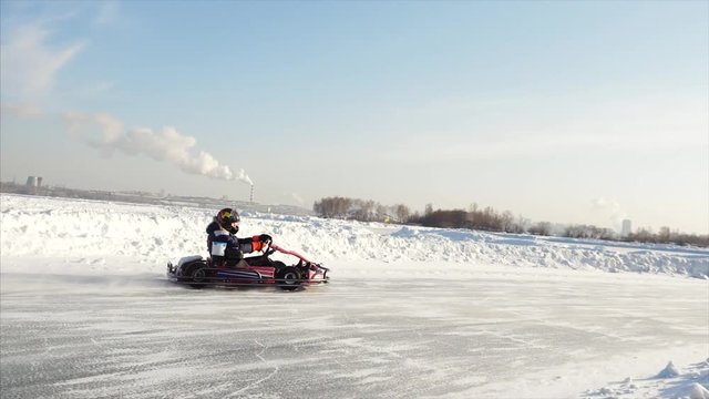 Winter karting competition on the ice track. Clip. Motion of go kart race in winter
