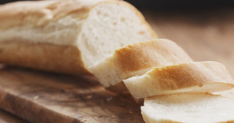 sliced baguette on wood board