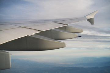 Obraz premium view of airplane wing during flight in midday