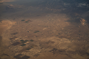 view from plane during flight over California mountains in sunset