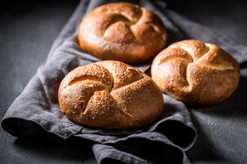 Tasty golden buns on dark grey concrete