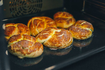 Hot cinnamon buns are baked in the oven