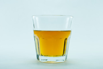 Glass of whiskey on white background