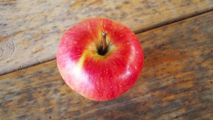 Fresh red Apple on wooden background.