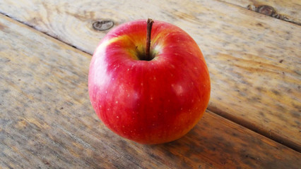 Fresh red Apple on wooden background.