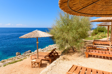 Sunbeds and umbrellas on Porto Limnionas beach on Zakynthos island, Greece