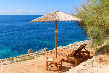 Sunbeds and umbrellas on Porto Limnionas beach on Zakynthos island, Greece