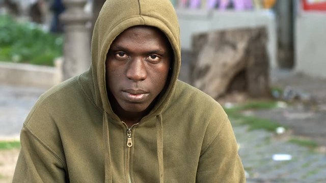 African black immigrant stares at the camera. Immigration, loneliness, problems