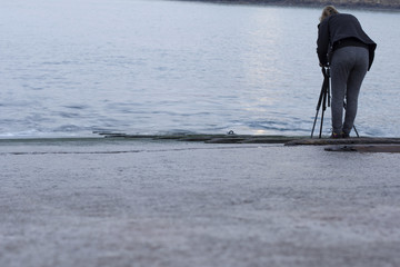 Photographer with a camera on a tripod
