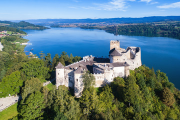 Poland. Medieval Castle in Niedzica, built in 14th century, artificial Czorsztyn Lake and far view of the ruins of Czorsztyn castle, Aerial view in the morning