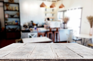 Selected focus empty brown wooden table and Coffee shop or restaurant blur background with bokeh image. for your photomontage or product display.