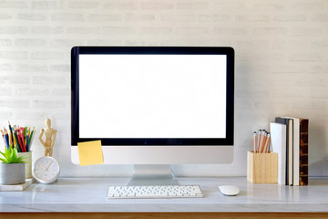 Blank screen on the desktop computer with house plant and office supplies, mock up