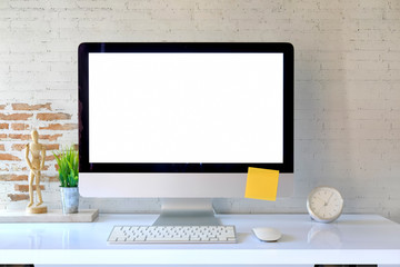 Blank screen on the desktop computer with house plant and office supplies, mock up
