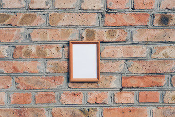 wooden picture frame on a brick surface background