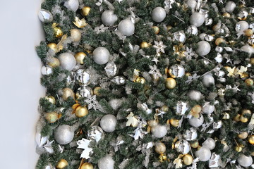 gold color Christmas ball hang on green pine tree with blurred night light new year party background.