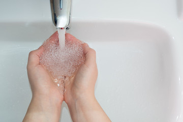 woman washing her hands in the bathroom