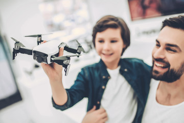 Dad and son in quadcopter store