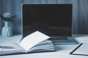 laptop and documents in the workplace.