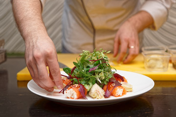 Chef is cooking salmon roll appetizer