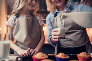 Grandmother and granddaughter cooking on kitchen