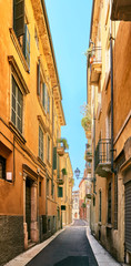Fototapeta na wymiar VERONA, ITALY - AUGUST 17, 2017: Narrow street of Verona high vibrant building facades.
