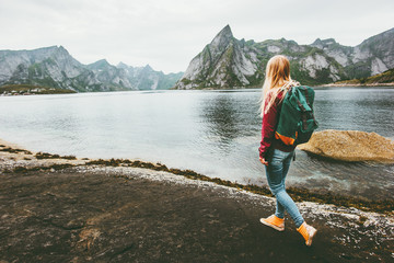 Backpacker woman walking alone in Norway lifestyle travel concept adventure outdoor summer vacations © EVERST
