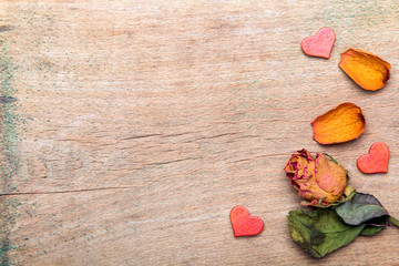 Fototapeta premium Dried orange roses on old wooden background, copy space