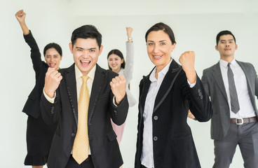 Happy business people cheering and showing thumb up at office. Happy time in the office.
