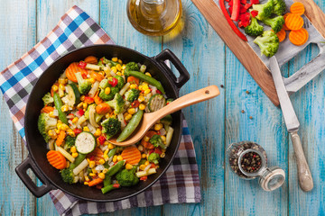 Mix of vegetables fried in a wok.