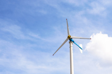 Wind turbine with blue sky and clouds, renewable energy, generate electricity