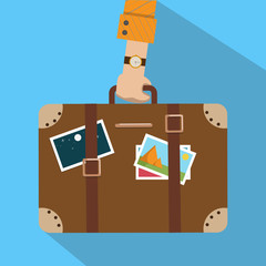 Travel bag, luggage. Man's hand holds suitcase with stickers. Flat style design. Summer time, vacation, tourism concept. Vector illustraton. © Julia