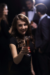 happy young woman raising glass in toast