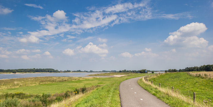 Panorama of a bicycle path along the river Waal