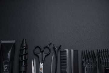 tools for cutting hair on a black background