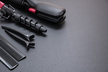 tools for haircuts and hair styling on a black background