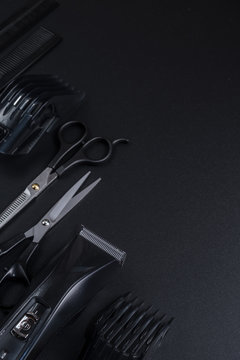 tools for cutting hair on a black background